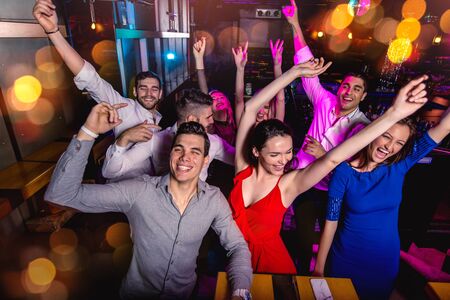 Group of friends partying in a nightclub