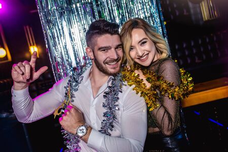Romantic young couple having fun in the night club. Man and woman in the pub.の写真素材