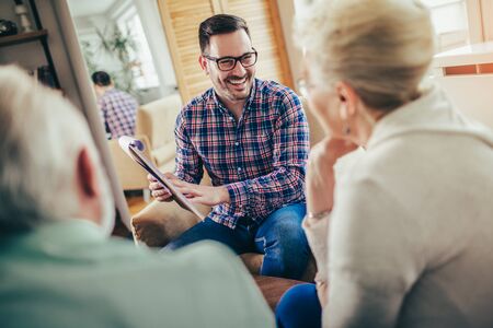 Positive aged couple consulting with insurance agentの写真素材