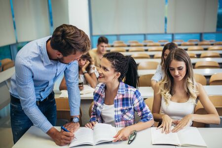Young students listening to professor in the classroom on collegeの写真素材