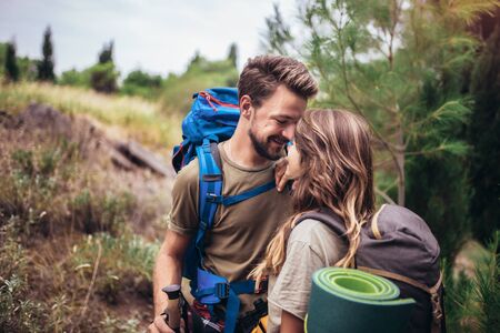 Romantic couple hiking on the path in mountainsの写真素材