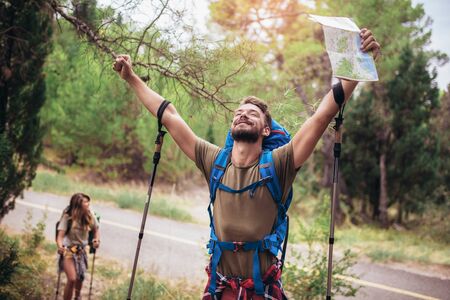 Backpackers hiking on the path in mountainsの写真素材