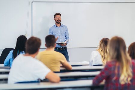 Young students listening to professor in the classroom on collegeの写真素材