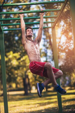 Fitness man doing workouts outdoors
