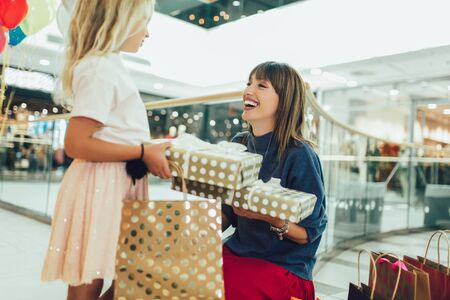 Mother and daughter having fun in shopping mall toghether.の写真素材