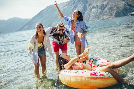 Happy friends having fun on beachの写真素材