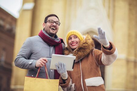 Young couple using a digital tablet for on line shopping.