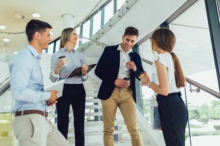 Group of businesspeople using a digital tablet together in office buildingの写真素材