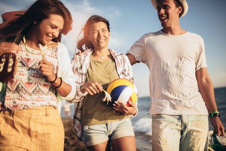  Young people looking happy on vacation. They are go on the beach party.