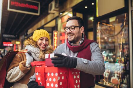 Young couple doing Christmas shopping in the city