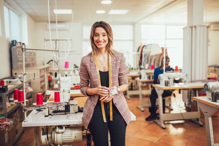 Portrait of happy dressmaker woman in studio.の写真素材