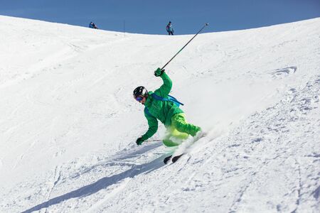Skier in mountains. Professional skier athlete skiing of ski resort.Winter vacation and sport concept.の写真素材