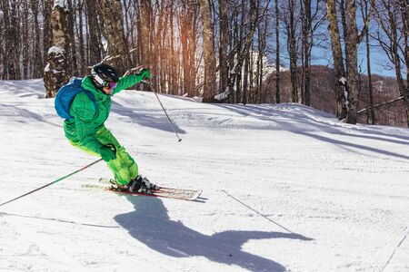 Skier in mountains. Professional skier athlete skiing of ski resort.Winter vacation and sport concept.の写真素材