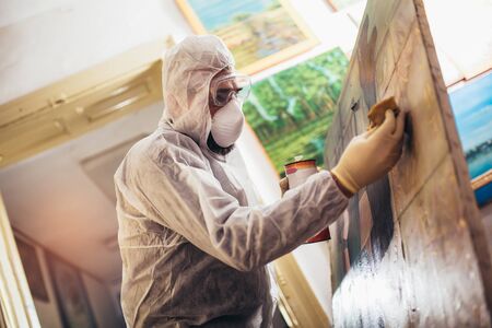 Restorer working on the painting at restoration workshopの写真素材