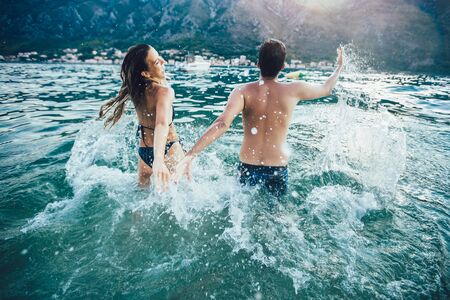 Sexy young couple on the beach having funの写真素材