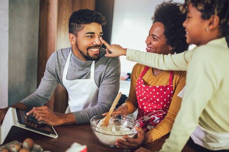 Happy black family spending day at kitchen.