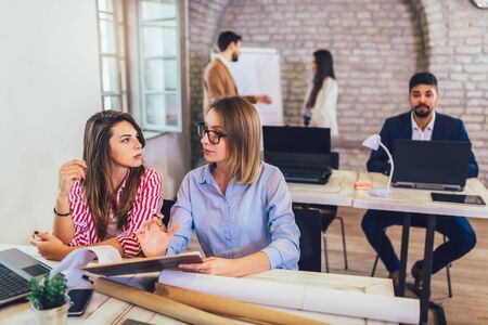 Young women working together in modern office.の写真素材