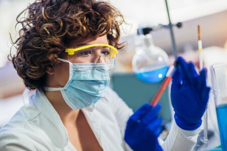 Lab technician assistant analyzing a blood sample at laboratory. Medical, pharmaceutical and...