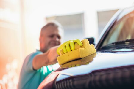 Car washing. Cleaning car using washing sponge.の写真素材