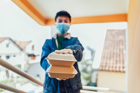 Teenage girl is delivering some groceries to an elderly person.の写真素材