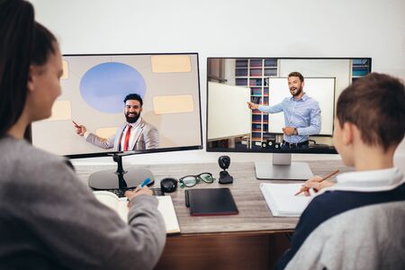 Boy and girl studies at home and doing school homework. Distance learning online education.の写真素材