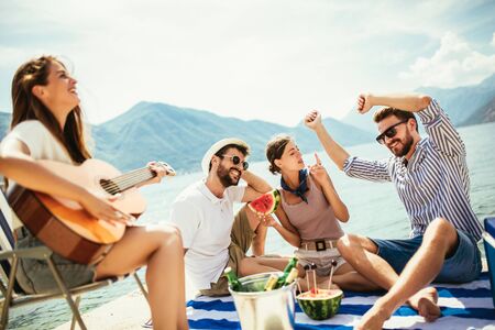 Happy young people having fun at beach party.の写真素材