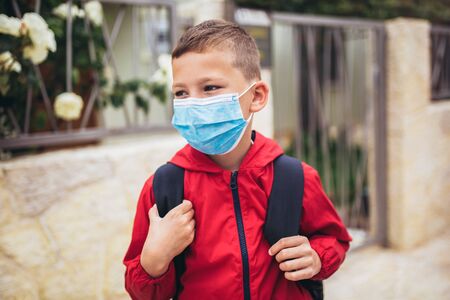 Child wear facemask during coronavirus and flu outbreak. The boy wear a mask before going to school...