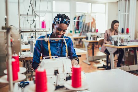 Dressmaker woman working with sewing machineの写真素材