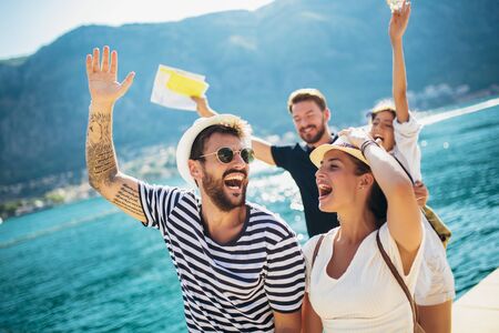 Group of friends having fun near the sea on vacationの写真素材