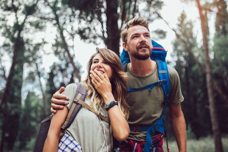 Couple trekking in a forestの写真素材