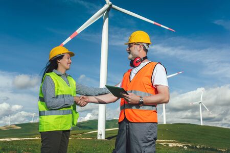 Windmill engineers inspection and progress check wind turbine
