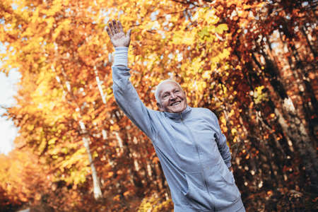 Senior Man Exercising In Park, having funの写真素材