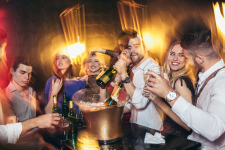 Happy young people having fun at nightclub.の写真素材