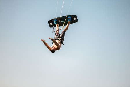Kitesurfing Kiteboarding action photos man among waves quickly goesの写真素材