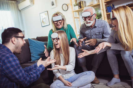 Three generation family spending time together at home playing game guess who.の写真素材