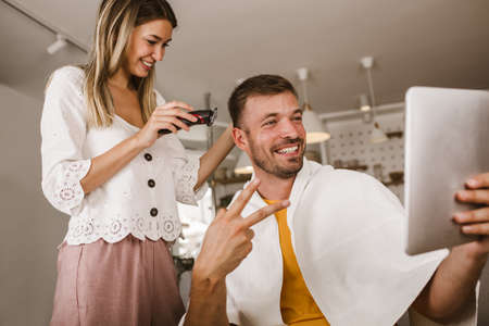 Couple having hair cut at home isolation coronavirus pandemicの写真素材
