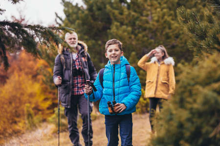 Father with son and daughter hiking in nature