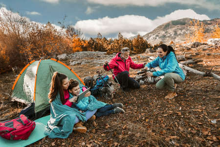 Happy family on a camping trip. Family doing camping in the forest