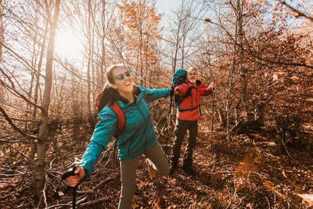 Mature Couple Hiking Along Forest Path Together