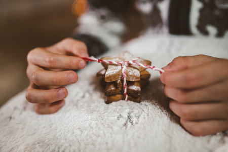 Boy packing Christmas gingerbread cookies. Christmas and New Year eve at home.