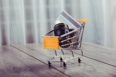 Small shopping cart with credit card inside- concept use credit for shopping.の写真素材
