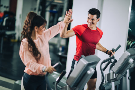 Fitness instructor with girl on training in fitness center