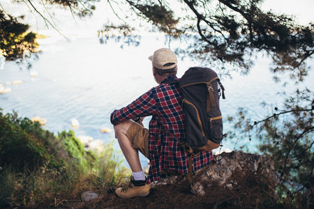 Mature man, hiking by the sea and exploring the natureの写真素材