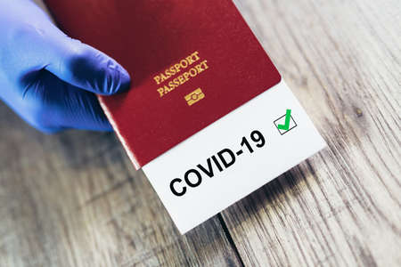 Travel and coronavirus concept, a note COVID-19 in tourist passport. Travel concept during the...