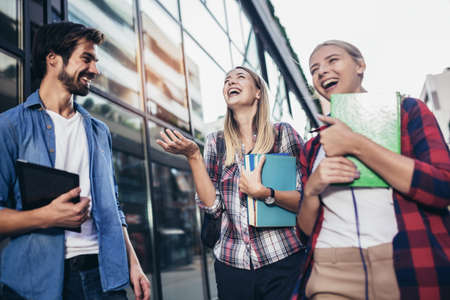 Education, campus, friendship and people concept. Group of happy students outdoorの写真素材