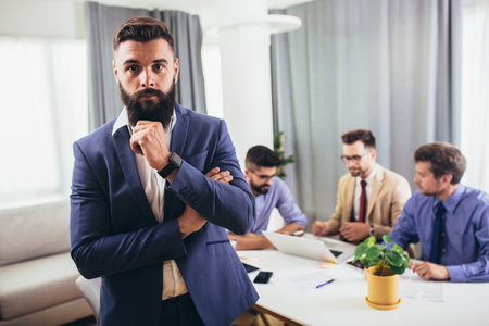 Leader ceo or professional business coach looking at camera posing in office with diverse happy team...