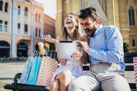 Young couple using a digital tablet for online shopping outdoor.の写真素材