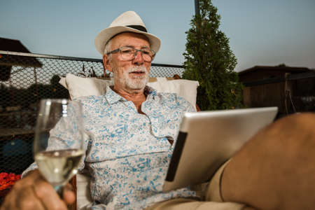 Senior man using digital tablet outdoor.の写真素材