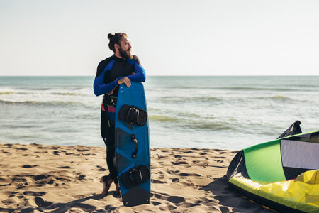 Surfer man with surf board on the beach. Summer sport activityの写真素材