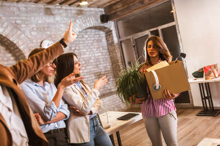 Fired woman with personal stuff in officeの写真素材